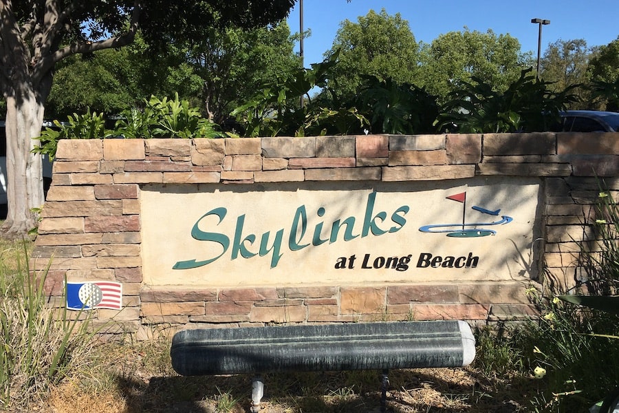 The logo on the sign is accurate — airplanes come in so low you'd think a wedge shot could bring them down.